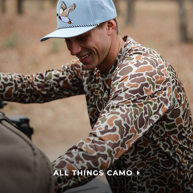 guy packing up a bag wearing a camo t-shirt