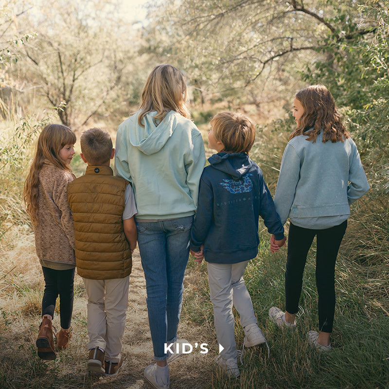 a group a kids walking on a trail