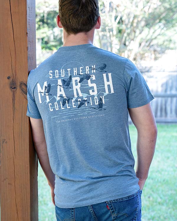 guy standing against a pole wearing a southern marsh t-shirt